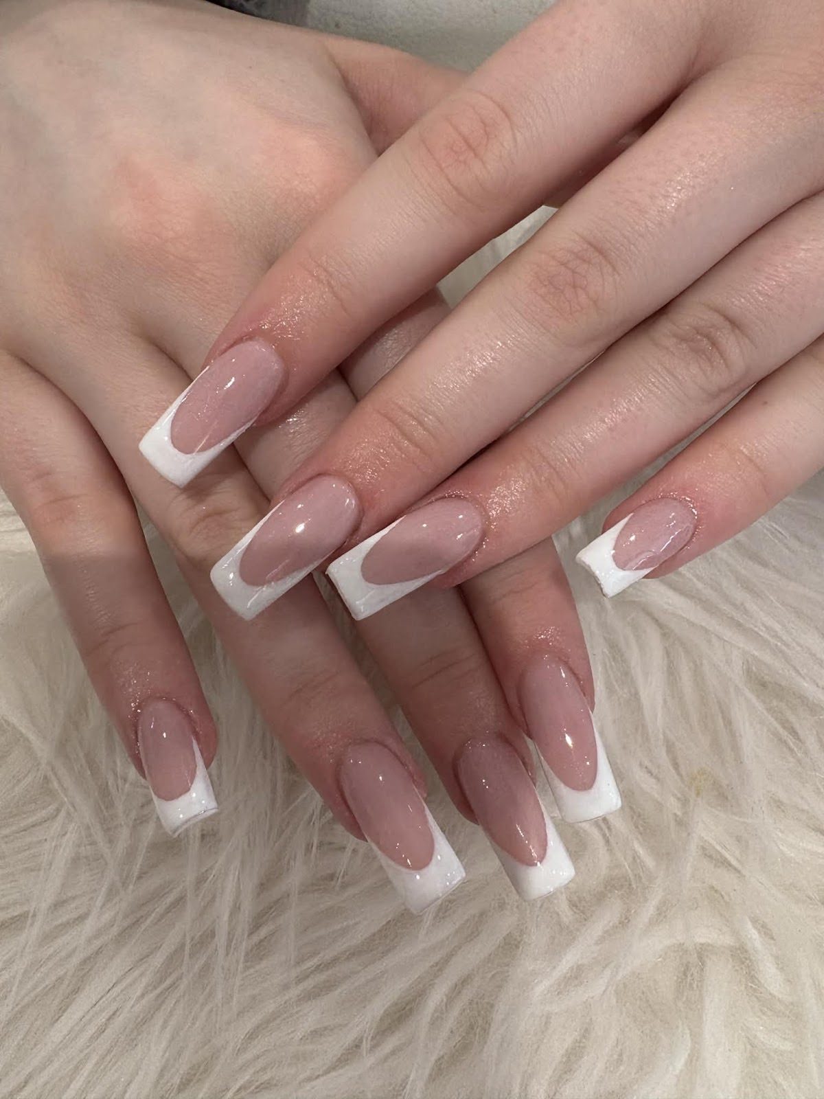 Long square-tipped classic white French extensions on both hands